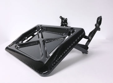 A carbon fiber footrest assembly for an aerospace seat made by aerospace manufacturing services