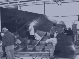 Workers building a mocked up full scale airplane fuselage made by rapid prototyping services