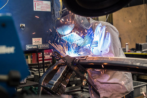 Someone welding to perform low volume production services